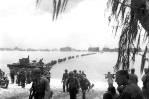 This July 1944 file photo shows U.S. Army reinforcement troops making an amphibious landing on the coral reef at Saipan beach, Mariana Islands. Racing against time, members of a Japanese organization are combing a New York military museum's World War II records for information they hope will lead to the graves of American servicemen still listed as missing in action on Saipan. (AP) <br/>