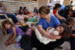Iraqi Christians who fled violence in the village of Qaraqush rest upon their arrival at the St. Joseph church in the Kurdish city of Irbil. <br/>Safin Hamed/AFP/Getty Images