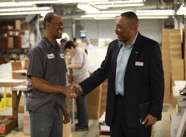 Chaplain Rickey Ezell greets an employee at Williamson Printing Corporation during a recent Marketplace Chaplain company visit. (Marketplace Chaplains) <br/>