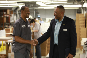 Chaplain Rickey Ezell greets an employee at Williamson Printing Corporation during a recent Marketplace Chaplain company visit. (Marketplace Chaplains) <br/>
