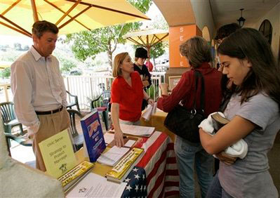 Skyline Church members Jeff Thomas, left, and Edy Johnson, center, hand out literature urging voters to pass Proposition 8 on Sunday, Sept 21, 2008 in San Diego. Alarmed by a California Supreme Court decision that legalized same-sex marriage, churches of many faiths have banded together in support of Proposition 8 which would amend the state constitution to define marriage as a union between a man and a woman. <br/>(Photo: AP Images / Lenny Ignelzi)