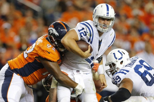 Indianapolis Colts quarterback Andrew Luck is hit by Denver Broncos' Sylvester Williams (AP) <br/>