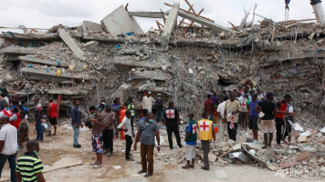 Rescue workers search for survivors in the rubble of a collapsed building belonging to the Synagogue Church of All Nations in Lagos, Nigeria. The building was being extended, adding three additional floors when it collapsed. (AP/Sunday Alamba) <br/>
