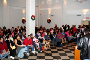 Hundreds of people waited with their children at Central Union Mission to be called to receive toy filled Christmas bags at Central Union Mission in Washington, D.C. on Saturday, December 23, 2006. <br/>