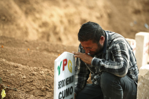 In this Saturday, file photo, Kurdish Ali Mehmud mourns at the grave of his brother Seydo Mehmud ‘Curo’, a Kurdish fighter, who was killed in the fighting with the militants of the Islamic State group in Kobani, Syria, and was buried at a cemetery in Suruc, Turkey. The Associated Press <br/>