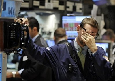 Trader Bradley Silverman rubs his eyes as he works on the New York Stock Exchange floor, Wednesday Oct. 1, 2008. <br/>(Photo: AP Images / Richard Drew)
