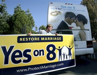 Richie Beanan from Los Angeles, puts a sign on a bus that will tour California in support of Proposition 8. after a rally in Sacramento, Calif., on Monday, Oct. 20, 2008. If passed Proposition 8 would amend the California state constitution to ban same sex marriage. <br/>(Photo: AP Images / Steve Yeater)
