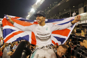 Mercedes F1 driver Lewis Hamilton of Britain celebrates with his team after winning the Abu Dhabi Grand Prix and the Drivers' World Championship title at the Yas Marina circuit in Abu Dhabi. Reuters <br/>