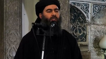 An image grab taken from a video released on July 5, 2014 by Al-Furqan Media shows alleged Islamic State of Iraq and the Levant leader Abu Bakr al-Baghdadi preaching during Friday prayer at a mosque in Mosul. (Al-Furqan Media/Anadolu Agency/Getty Images) <br/>