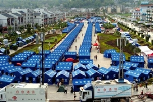 In this photo released by China's Xinhua News Agency, tents are set up in Ning'er County, in southwest China's Yunnan Province, on Monday, June 4, 2007. Tens of thousands of earthquake victims in southwest China were living in tents or in the open Monday, fearful of returning to their damaged homes a day after a magnitude 6.4 quake killed three and injured at least 300. <br/>(AP Photo/Xinhua, Qin Qing) 