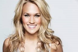 Former ''American Idol'' winner Carrie Underwood has topped both secular and Christian music charts in 2014. <br/>