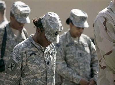 U.S soldiers of Combined Security Transition Command stand silent and bow their heads during a ceremony marking Veterans Day at the Camp Eggers in Kabul, Afghanistan, Tuesday, Nov. 11, 2008. <br/>(Photo: AP Images / Rafiq Maqbool)