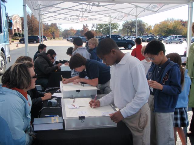 Hundreds of students, teachers, parents and people from the community line up to write a verse from the Bible at the Casady Prep School in Oklahoma City. <br/>(Photo: Bible Across America)