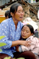 In this photo released by China's Xinhua News Agency, earthquake victims Pu Shanshan, right, and her aunt cry at Kun'e Village in Ning'er County, in southwest China's Yunnan Province, Tuesday, June 5, 2007. A magnitude 6.4 quake struck the area on Sunday, killing three and injuring at least 300. <br/>(AP Photo/Xinhua, Qin Qing) 