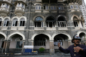 A fireman gestures outside Taj Mahal hotel in Mumbai, India, Saturday, Nov. 29, 2008. <br/>(AP / Gautam Singh)