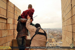 In the video released by ISIS, the man is pushed off a tower block to his death by two masked miltants. <br/>