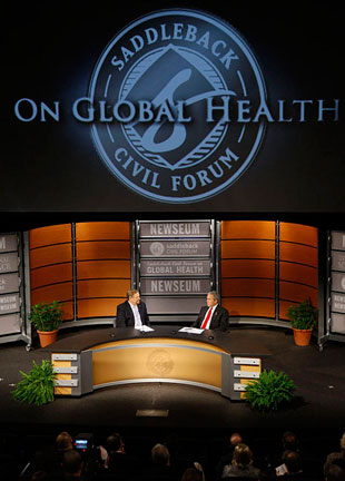 President George W. Bush speaks with Pastor Rick Warren Monday, Dec. 1, 2008, during President Bush's participation at the Saddleback Civil Forum on Global Health at the Newseum in Washington, D.C. <br/>(White House/Eric Draper)