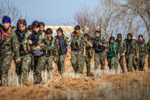 Female fighters of the Kurdish People's Protection Units (YPG) carry their weapons as they walk in the western countryside of Ras al-Ain January 25, 2015. REUTERS/Rodi Said  <br/>