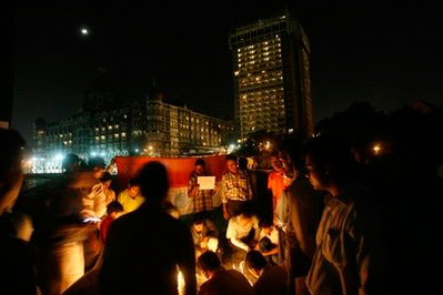 People participate in a candlelit vigil held outside the Taj Mahal hotel, in background, to pay tribute to the victims of the Mumbai attacks, in Mumbai, India, Tuesday, Dec. 2, 2008. <br/>(Photo: AP Images / Gautam Singh)
