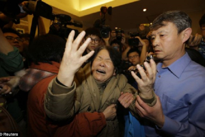 A heartbroken family member of a passenger aboard Malaysia Airlines MH370 cries after hearing the flight was missing. Reuters <br/>