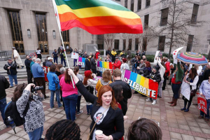 A woman holds a flag as she joins other gay marriage supporters in Linn Park, at the Jefferson County courthouse, Feb. 9, 2015, in Birmingham, Ala. Hal Yeager/AP Photo <br/>