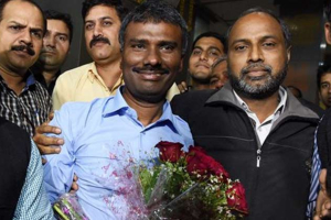Father Kumar pictured during his joyful arrival at New Delhi's airport. Photo: PTI Photo <br/>