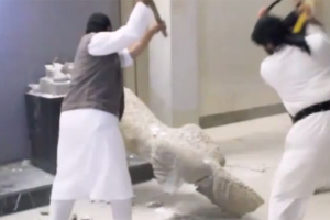 Islamic State militants destroy priceless artifacts in Mosul, Iraq on Thursday in a campaign to eliminate what they see as heresy. Photo: YouTube <br/>