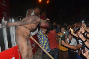 An accused rapist is beaten and tortured by Indian civilians on Thursday. Photo: AFP/Getty Images <br/>