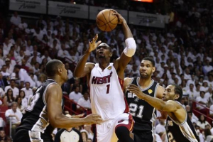 June 12, 2014; Miami, FL, USA; Miami Heat center Chris Bosh (1) shoots against San Antonio Spurs forward Boris Diaw (left). Reuters <br/>