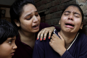 Girls mourn a family member killed in a suicide bombing attack near two churches in Lahore, Pakistan, on Sunday. K.M. Chaudary/AP <br/>