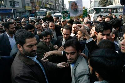 Iranian President Mahmoud Ahmadinejad, center left, attends an anti-Israeli demonstration in Tehran, Iran, Friday, Dec. 12, 2008. Thousands of Iranians stage demonstrations to protest Israel of the consequences of the ongoing siege of the militant Hamas-run Gaza Strip. Ahmadinejad repeatedly has called for Israel's destruction. A poster, at rear, shows late spiritual leader and founder of Hamas movement, Sheik Ahmed Yassin. <br/>(Photo: AP Images / Vahid Salemi)